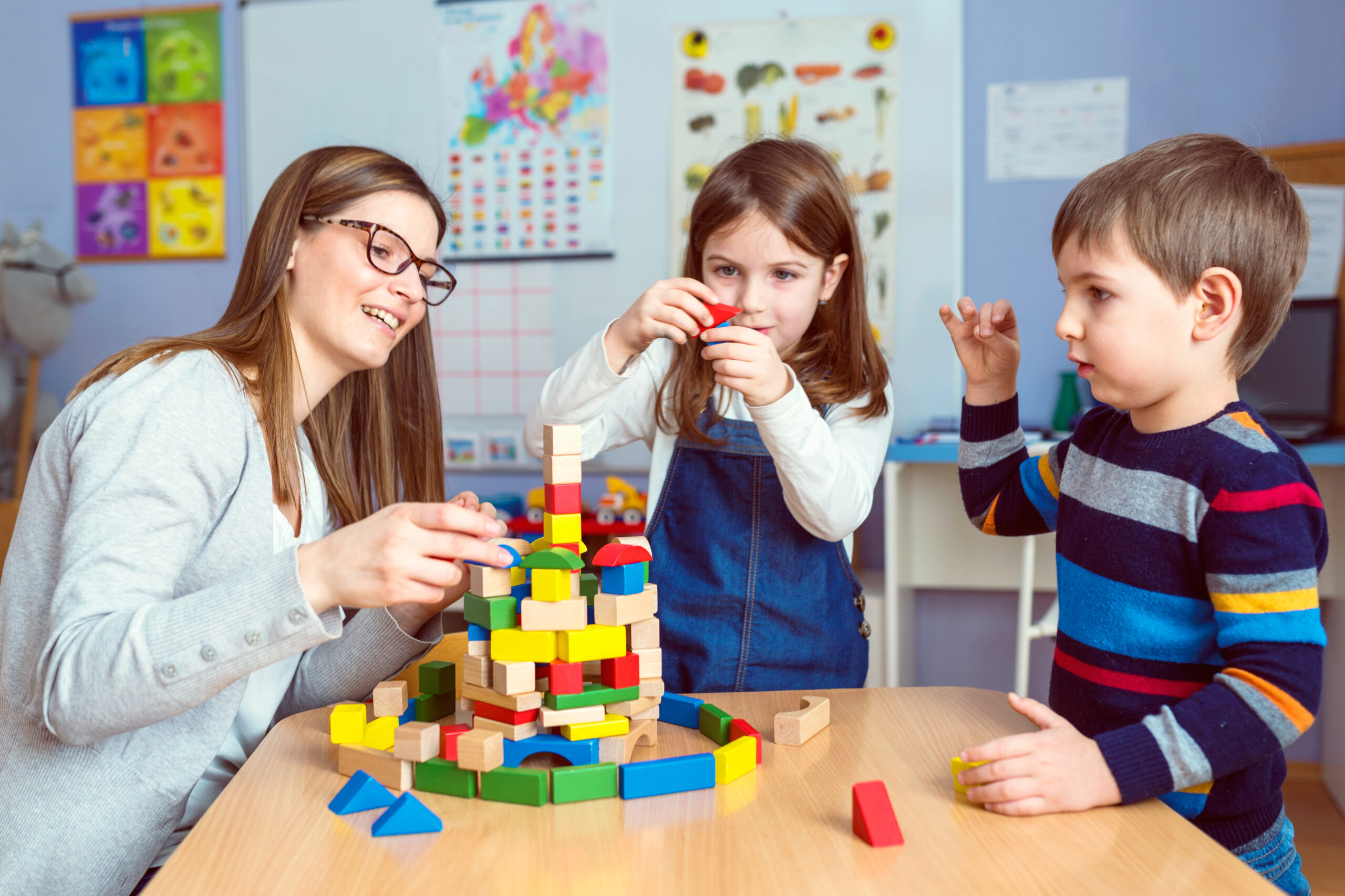 Teacher,And,Kids,Playing,Together,With,Colorful,Toy,Building,Blocks Kids learning at Soans Christian Academy
